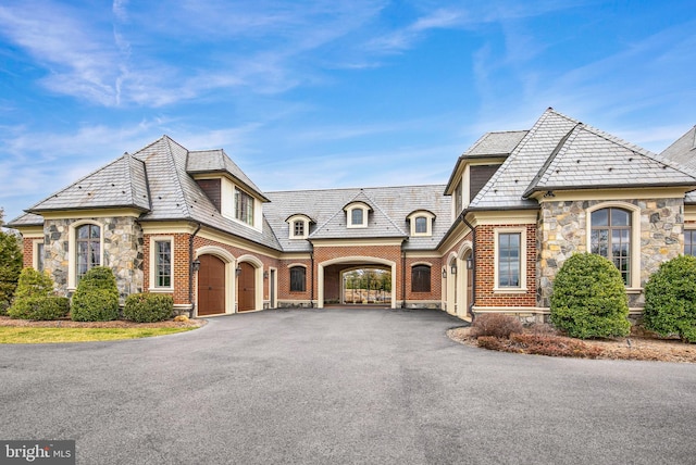 french country style house with a garage