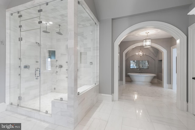 bathroom with a chandelier, tile patterned flooring, independent shower and bath, and vaulted ceiling