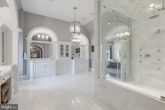 bathroom featuring tile patterned flooring, vanity, and walk in shower