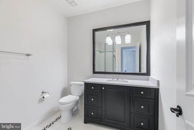 bathroom featuring toilet, vanity, and tile patterned floors