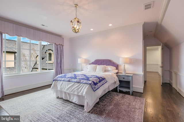 bedroom with crown molding, lofted ceiling, dark wood-type flooring, and a chandelier