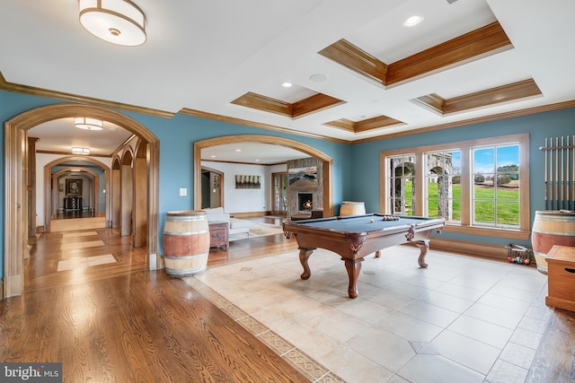 playroom with coffered ceiling, crown molding, light wood-type flooring, a fireplace, and pool table