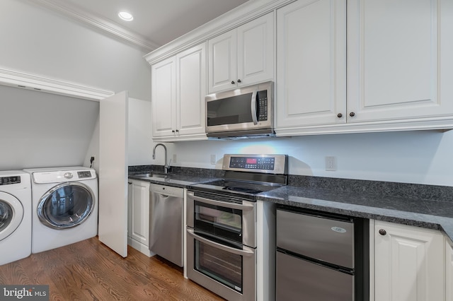 kitchen with stainless steel appliances, crown molding, sink, washing machine and dryer, and white cabinetry