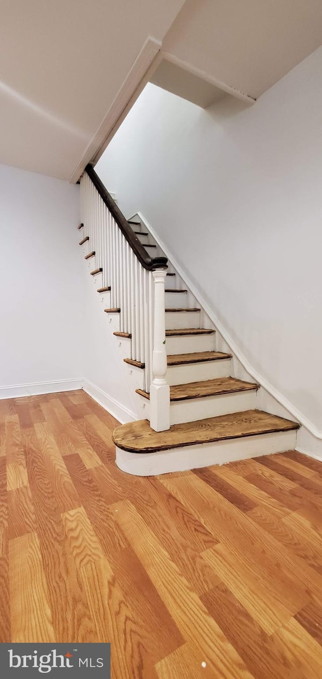 staircase featuring light hardwood / wood-style flooring