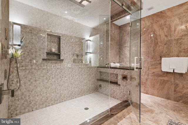 bathroom featuring walk in shower, tile flooring, and tile walls