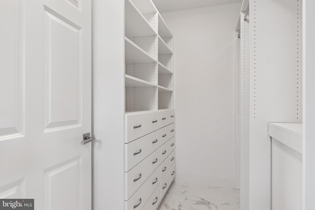 walk in closet featuring light tile floors