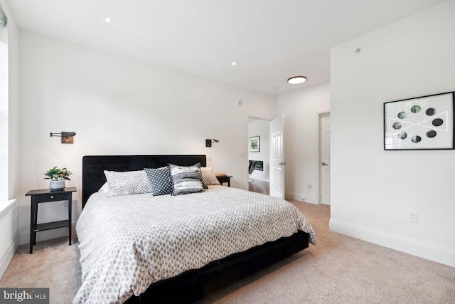 bedroom featuring light carpet