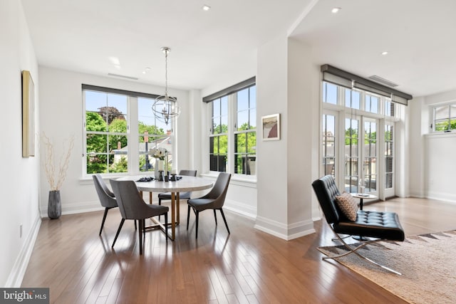 dining room with a notable chandelier and hardwood / wood-style flooring