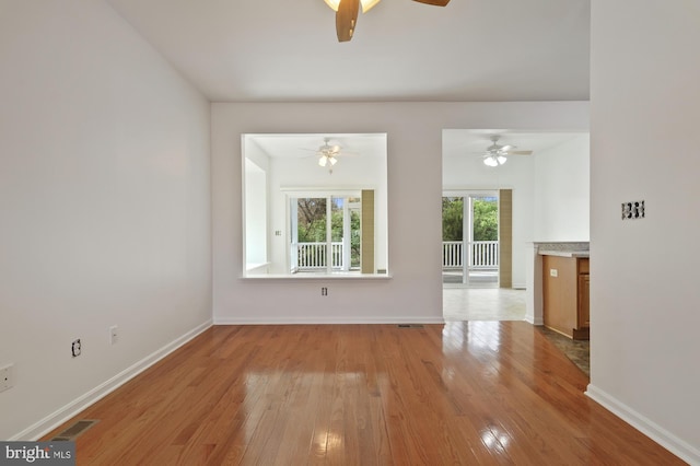 spare room with ceiling fan and light hardwood / wood-style flooring