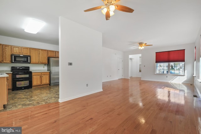 kitchen featuring black appliances, ceiling fan, and light hardwood / wood-style flooring