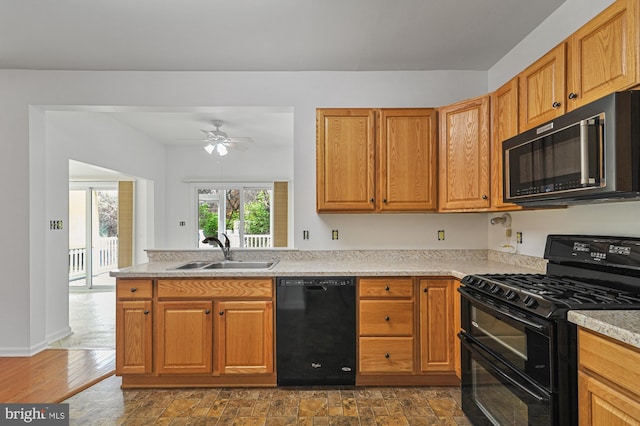 kitchen with dark wood-type flooring, light stone counters, ceiling fan, sink, and black appliances