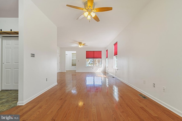 unfurnished living room featuring ceiling fan and light hardwood / wood-style floors