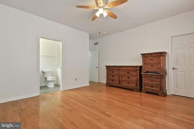 unfurnished bedroom featuring light hardwood / wood-style flooring, ceiling fan, and ensuite bath