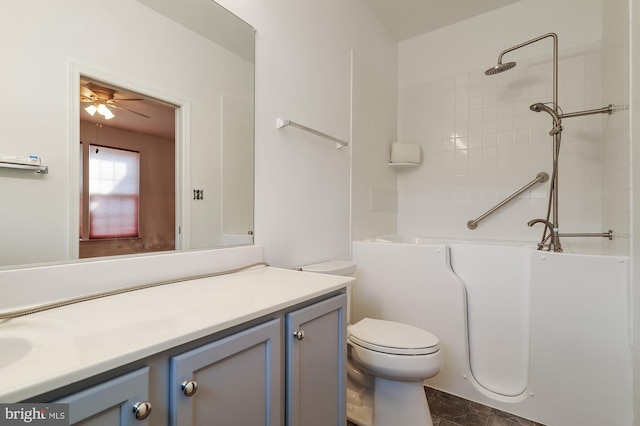 full bathroom with tile floors, tiled shower / bath combo, ceiling fan, toilet, and vanity