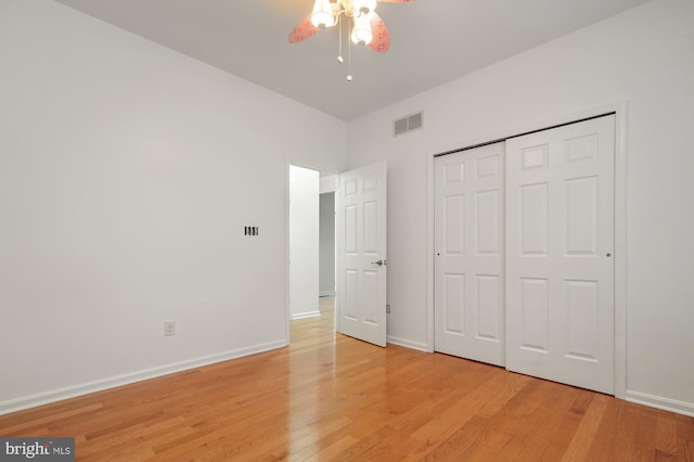 unfurnished bedroom with ceiling fan, light hardwood / wood-style floors, and a closet