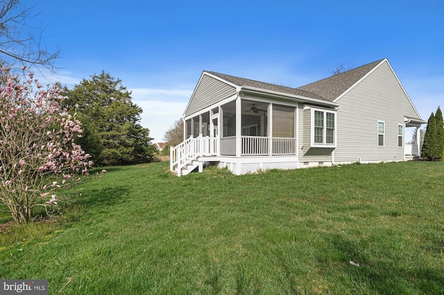 exterior space featuring ceiling fan and a front yard