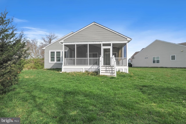 back of house with a sunroom and a lawn