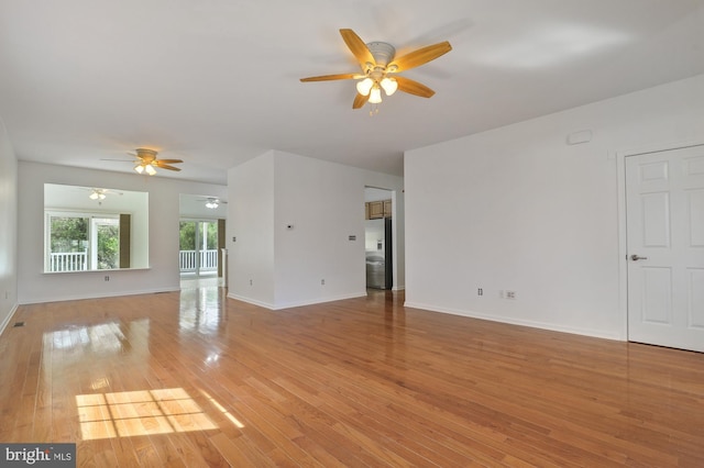 empty room featuring ceiling fan and light wood-type flooring