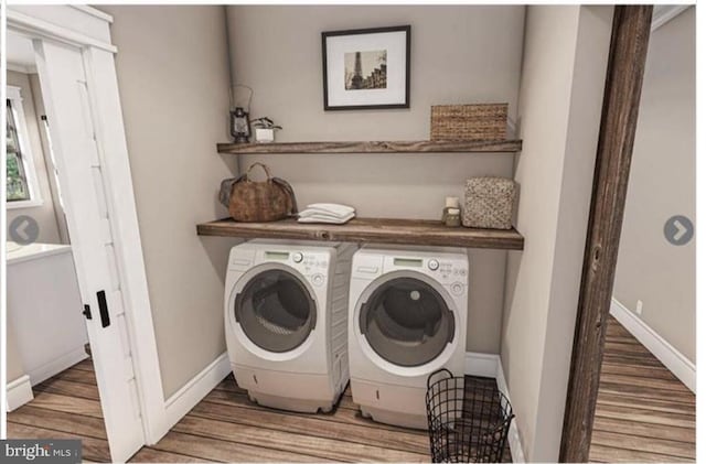 laundry room with separate washer and dryer and hardwood / wood-style flooring