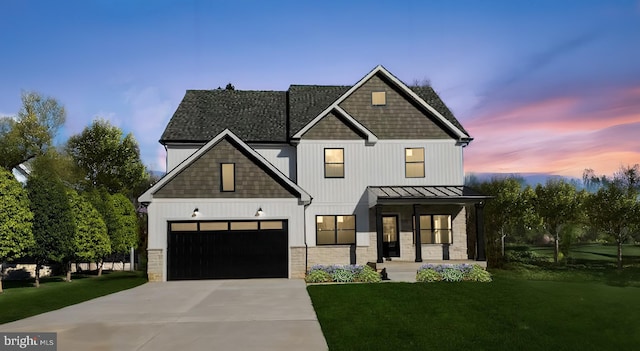 modern farmhouse style home with a lawn and a garage