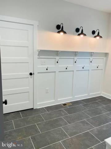 mudroom featuring dark tile patterned flooring