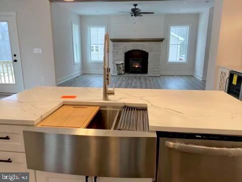 kitchen featuring dishwasher, white cabinetry, dark hardwood / wood-style flooring, and light stone countertops