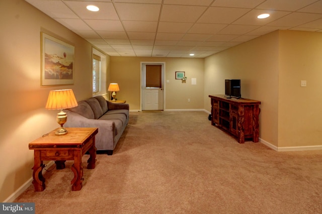 carpeted living room featuring a paneled ceiling