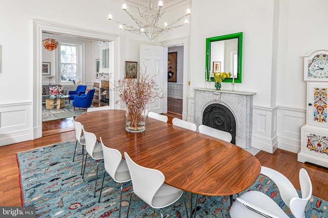 dining area with dark hardwood / wood-style flooring and an inviting chandelier