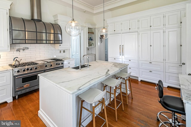 kitchen with white cabinets, a kitchen breakfast bar, double oven range, and light stone counters