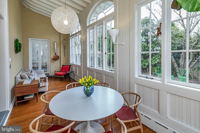 sunroom featuring beamed ceiling and a baseboard radiator