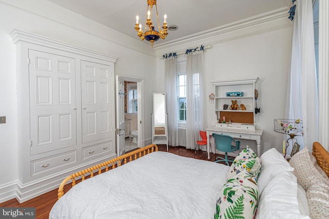 bedroom featuring a closet, dark hardwood / wood-style flooring, and a chandelier