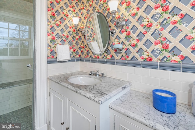 bathroom featuring tasteful backsplash, oversized vanity, and tile walls