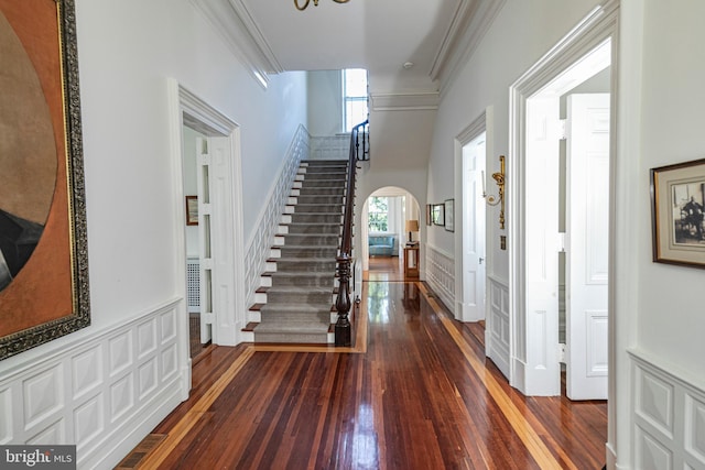 entryway featuring ornamental molding and dark hardwood / wood-style flooring