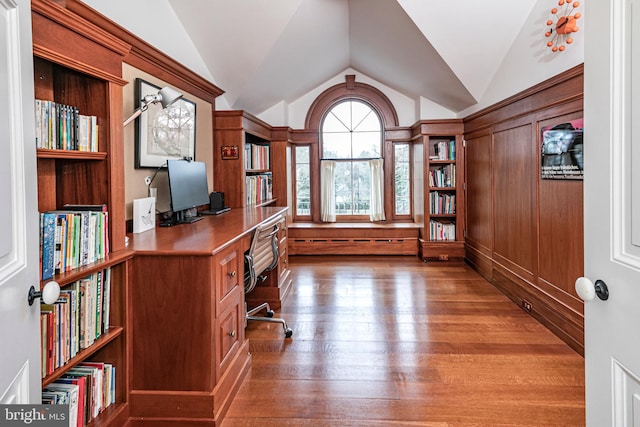 unfurnished office with vaulted ceiling and dark hardwood / wood-style flooring