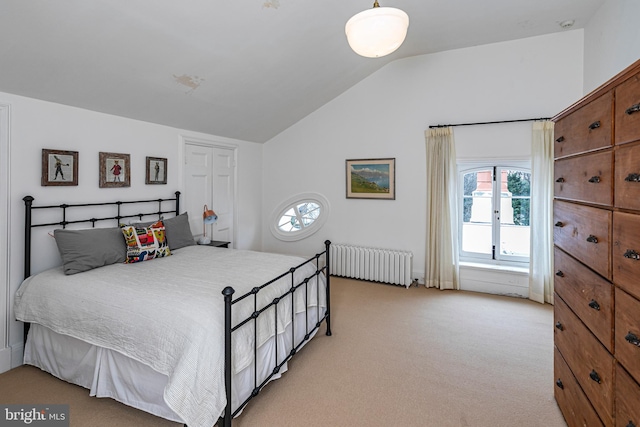 bedroom featuring light colored carpet, radiator heating unit, and lofted ceiling