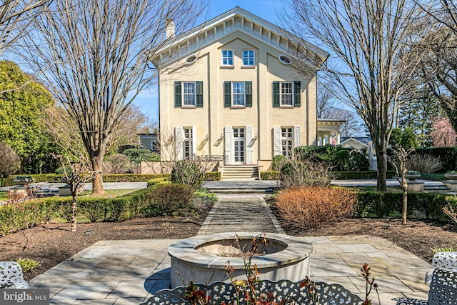 view of front facade with a patio area and an outdoor fire pit