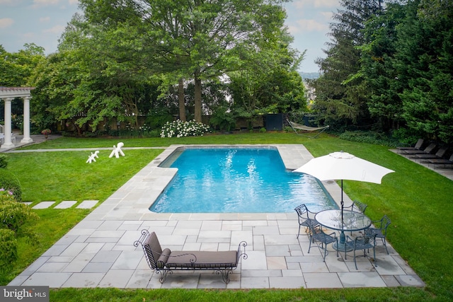 view of swimming pool featuring a yard, a pergola, and a patio