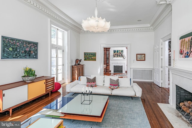 living room featuring a high end fireplace, dark hardwood / wood-style flooring, and crown molding