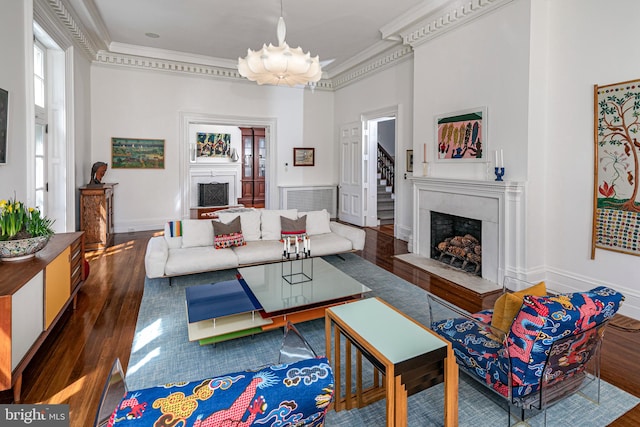 living room with a wealth of natural light, crown molding, and dark hardwood / wood-style flooring