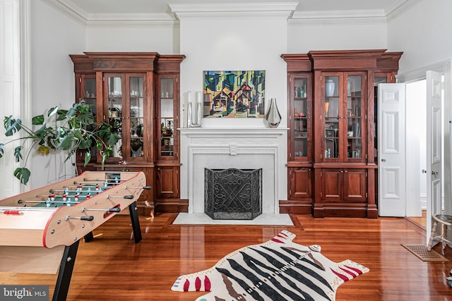 living room featuring ornamental molding and dark wood-type flooring