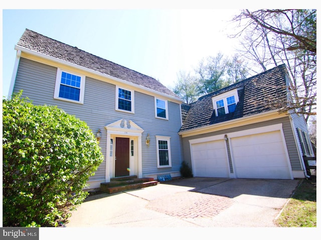 colonial inspired home featuring a garage