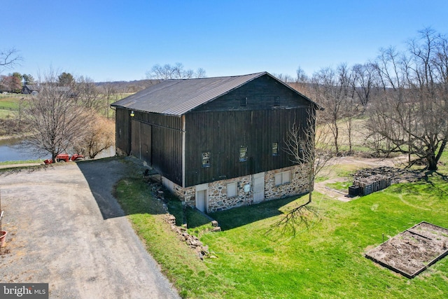 view of outbuilding featuring a yard