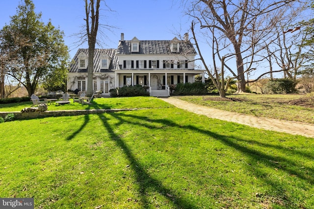 view of front of house with covered porch and a front yard