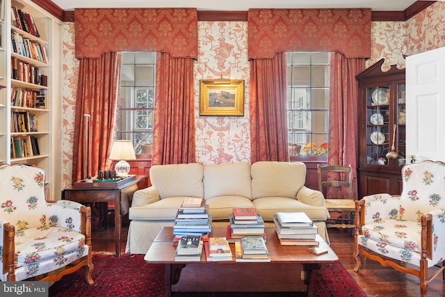 living room featuring crown molding, built in features, and wood-type flooring