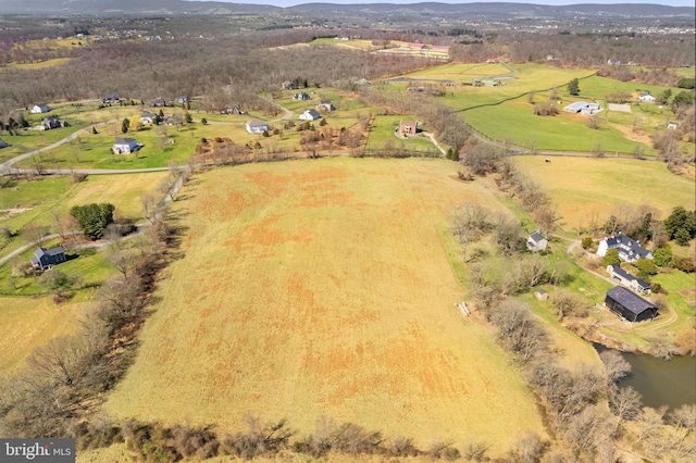 birds eye view of property with a water view and a rural view