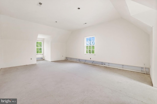 bonus room featuring a baseboard radiator, a healthy amount of sunlight, and vaulted ceiling