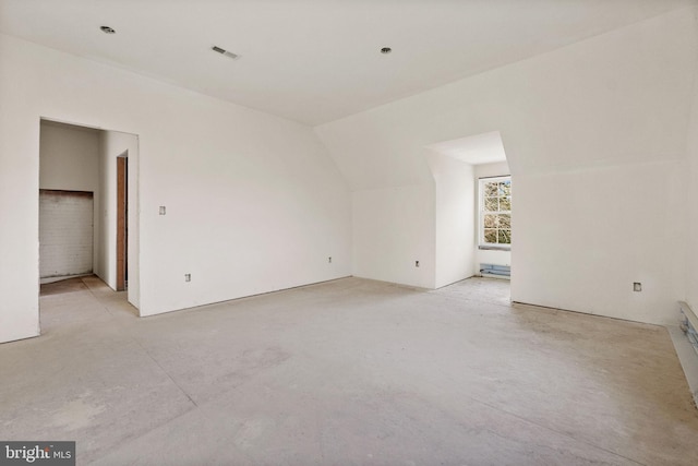 spare room with vaulted ceiling