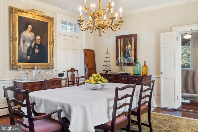 dining space with dark hardwood / wood-style flooring, an inviting chandelier, and crown molding