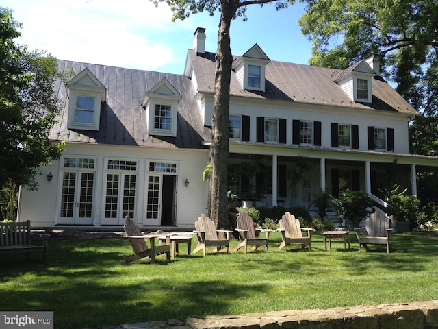 rear view of property featuring french doors and a yard