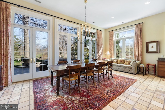 dining room featuring french doors and an inviting chandelier